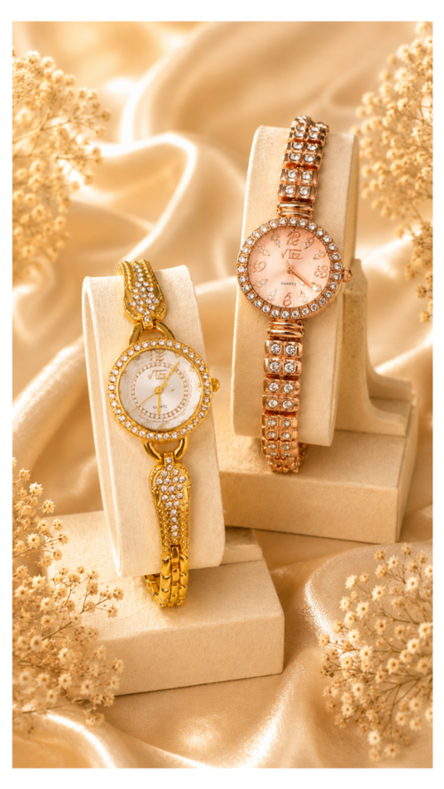 Two women's watch bracelets displayed on cream jewelry stands, set against a draped champagne satin background with dried floral accents. One watch has a gold-tone case and bracelet with a white dial and crystal embellishments.